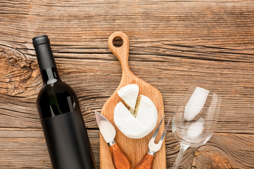 top-view-camembert-wooden-cutting-board-wine-glass_23-2148376010